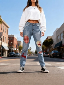 Women's ripped slim fit jeans featuring festive red reindeer and plaid Christmas patches
