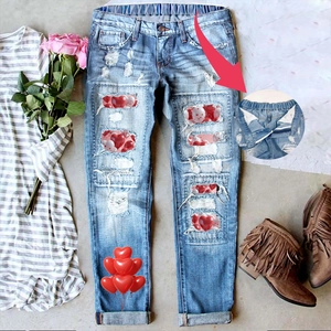 Women's light blue distressed straight jeans with heart print patches and elastic waist