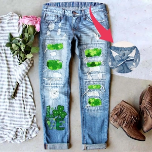 Women's light blue distressed jeans with St. Patrick's shamrock patches and elastic waist