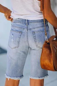 Women's light blue distressed denim shorts with frayed edges and ripped back pockets
