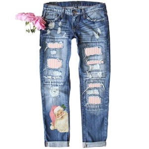 Distressed dark blue denim jeans for women with Christmas Santa print and striped patches