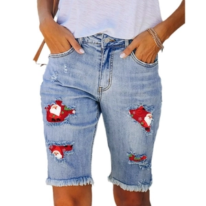 Light blue ripped denim shorts with festive Santa patches and fringe hem details