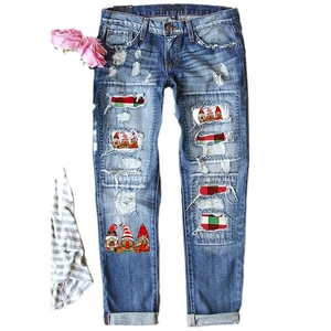 Women's ripped blue denim jeans with Christmas gnome patches and plaid holiday patterns