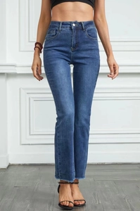 High waist bootcut jeans in dark blue with raw hem edge on white background