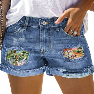 Women's mid-waist blue denim shorts with colorful bird and koala print patches