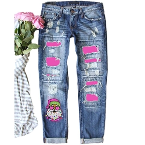 Women's blue distressed jeans with Christmas Santa print and pink patchwork details