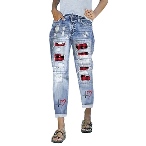Distressed light blue jeans with buffalo plaid patches and heart print design