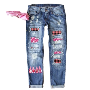 Women's ripped wide leg jeans in blue denim with festive gnome love prints and patches