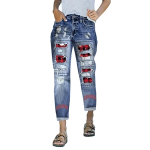 Detail of distressed blue jeans featuring red buffalo plaid patches and Chicago text print