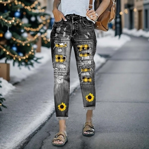Distressed grey jeans with sunflower prints and yellow plaid patches in a street style