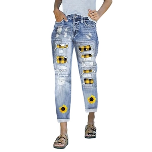 Women's light blue distressed sunflower denim jeans with plaid patches and fringe