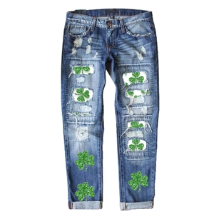 Mid-rise straight leg distressed jeans with St. Patrick's Day green glitter shamrock prints