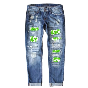 Women's straight-leg blue jeans with green shamrock patches and distressed details