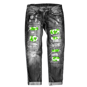 Deep charcoal distressed denim jeans with bright green clover print inserts and rolled cuffs