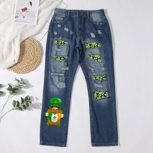 Blue washed ripped jeans with green shamrock patches and gnome print for St. Patrick's Day