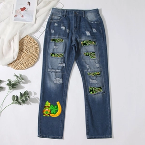Distressed dark blue straight-leg jeans with green shamrock patches and festive print