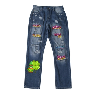 Distressed blue straight jeans featuring mosaic patches and clover gnome print