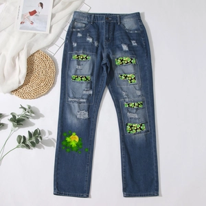 Men's dark blue straight jeans featuring St. Patrick's Day clover patches and distressed details