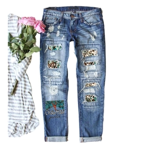 Distressed blue ripped jeans with leopard and turquoise patches and crawfish graphic