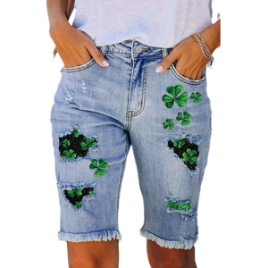 Mid-rise denim shorts with shamrock print and distressed frayed hem in light blue wash