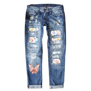 Distressed blue Easter bunny denim jeans with colorful egg patches and floral rabbit print