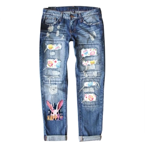 Women's blue ripped jeans with Easter egg floral patches and happy rabbit print design
