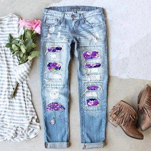 Women's light blue straight-leg jeans with floral patches and umbrella embroidery print