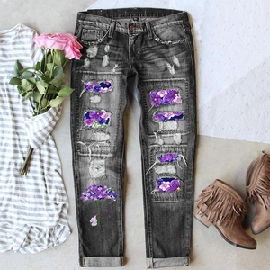 Women's dark grey ripped jeans with floral patches and umbrella print flat lay display