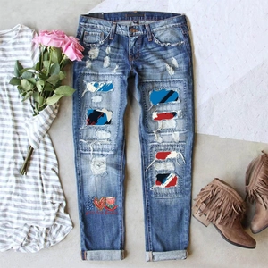 Mid-rise distressed blue jeans with patriotic USA flag patches and peace love freedom print