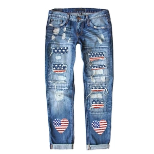 Women's vintage blue ripped jeans with American flag patches and a straight-leg fit