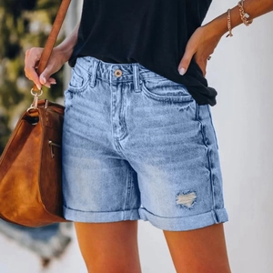 Light blue high waist denim shorts with heart-shaped distressed detail and rolled cuffs