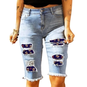 Summer high waist ripped denim shorts with light blue wash and distressed frayed hem details