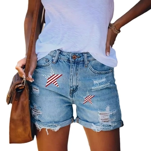 Women's light blue distressed denim shorts featuring American flag star patches and frayed edges