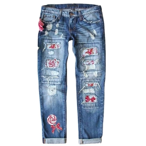 Distressed blue denim straight jeans with festive red plaid and candy pattern patches