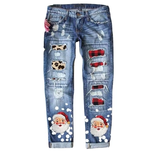 Distressed Christmas denim pants with Santa print, plaid patches, and leopard accents