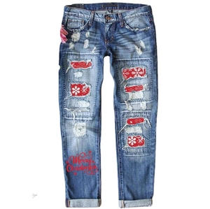 Distressed dark blue slim jeans with festive red snowflake patches and Merry Christmas print