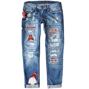 Women's Christmas distressed jeans with gnome patches and snowflake print in blue wash