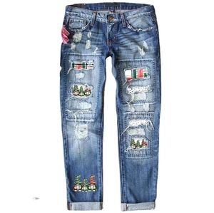 Blue denim jeans with Christmas gnome patches and red plaid ripped distressed details