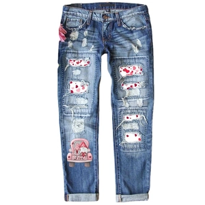 Women's blue distressed jeans with red heart patterns and cute gnome truck print