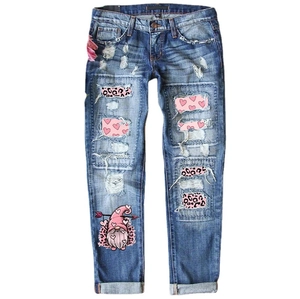 Mid-rise blue jeans with heart patches, pink leopard print, and cartoon gnome design
