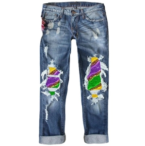 Women's straight jeans with distressed knees and vibrant sequined heart print inserts