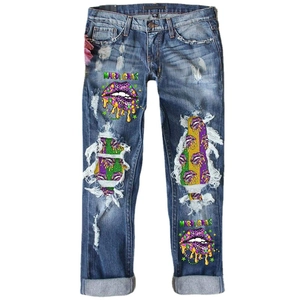 Blue straight-leg distressed jeans with Mardi Gras print and colorful striped patchwork
