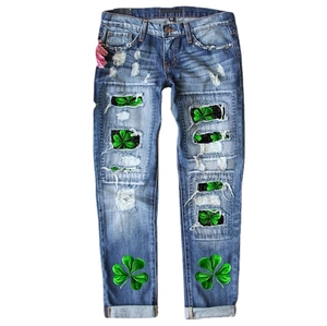 Women's blue straight leg jeans with clover print and distressed ripped detailing