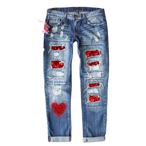 Women's blue straight-leg jeans with red heart sequins and distressed ripped details