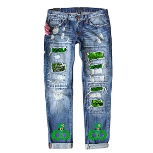 Women St. Patrick's Day ripped jeans in dark blue with green shamrock prints
