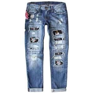 Distressed straight-leg jeans featuring vintage patches and Gamma Phi Delta embroidery