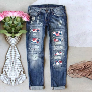 Deep blue washed distressed jeans with American flag patches and vintage street style