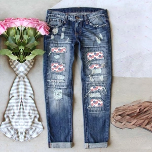 Distressed straight leg jeans with American flag patches and vintage wash finish