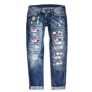 Straight fit blue washed jeans featuring distressed American flag star and stripe patches