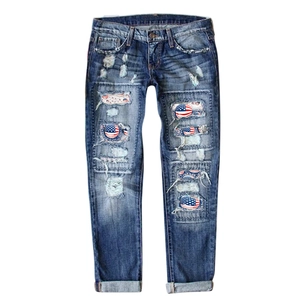 Women's mid-blue ripped straight jeans with patriotic American flag patches and distressed details
